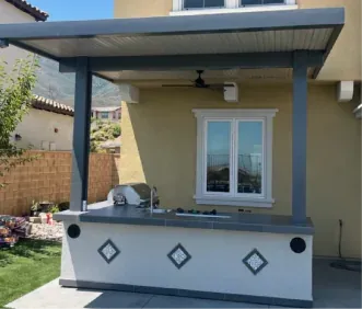 Aluminum patio cover over a white BBQ island with diamond accent tiles