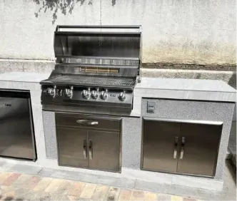 Gray BBQ island with built-in stainless grill, fridge and storage doors